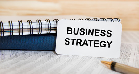inscription on business card BUSINESS STRATEGY, next to the pen, ungiga and accounting. A business...