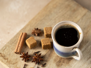 Cafe de olla, traditional Mexican coffee beverage with panela and spice and prepared in clay pot.