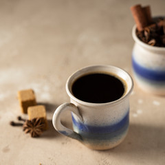 Cafe de olla, traditional Mexican coffee beverage with panela and spice and prepared in clay pot.