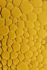 Current collection of brilliant backgrounds for your design. Close-up shot of flattened oil drops on water surface in yellow color.