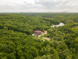 Fototapeta na wymiar Aerial drone view. Buildings in the forest in Kiev.