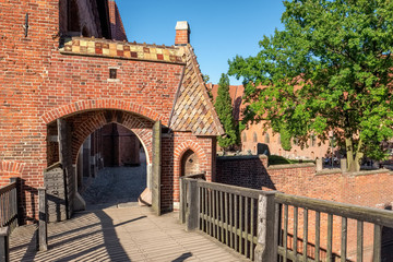 Entrance to the Teutonic Castle in Malbork or Marienburg at summer in Poland