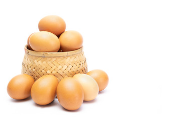 Fresh chicken eggs in the bamboo woven and on the floor isolated on white background. selective focus, soft focus.