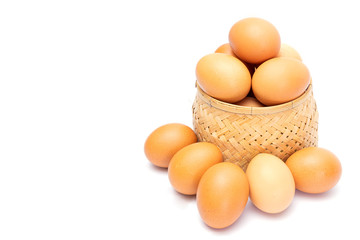 Fresh chicken eggs in the bamboo woven and on the floor isolated on white background. selective focus, soft focus.