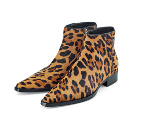 Women's half-boots made of pony fur with a leopard print with a pointed tip on the zipper. Fashionable model of demi-season shoes isolated on white background. Top view at an angle.