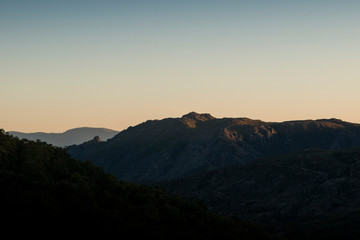 Mountain shapes fading at sunset