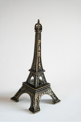 eiffel tower statue on white background, small copy