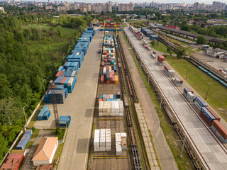 Fototapeta na wymiar Multicolored freight containers on the railroad. Aerial drone view.