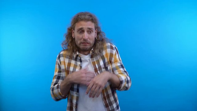 a comedic man looks with disgust at something nasty and terrible. 4K