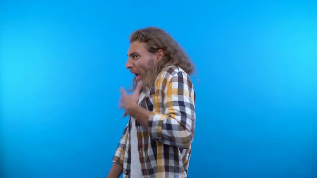 a hipster man looks at the camera with disgust. 4K