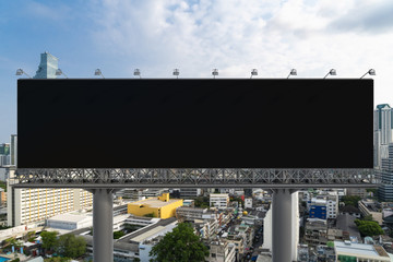 Blank black road billboard with Bangkok cityscape background at day time. Street advertising poster, mock up, 3D rendering. Front view. The concept of marketing communication to promote or sell idea.