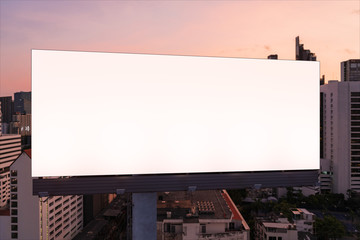 Blank white road billboard with Bangkok cityscape background at night time. Street advertising poster, mock up, 3D rendering. Front view. The concept of marketing communication to promote idea.
