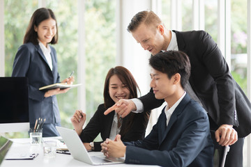 Group of diverse nationality professional look business man and woman meeting or reporting business result or financial report in meeting room and a boss or leader praises or applaud his team member.