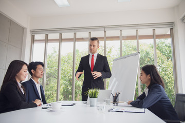 Group of young diverse business people meeting or discussing about their business seriously in office together.