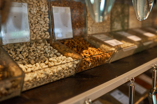 .Shelves with glass cells filled with nuts and cereals..Zero waste shopping concept
