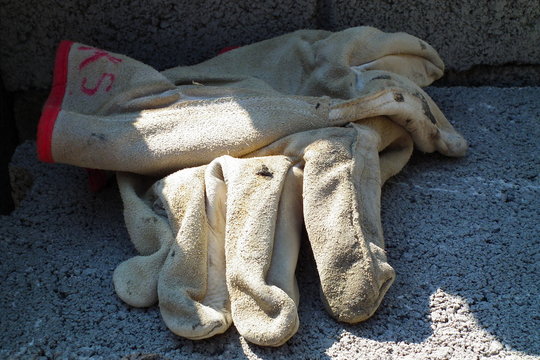A apir of glowes on the ground.