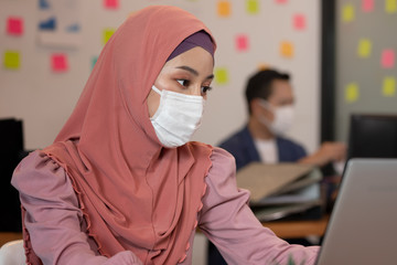 Business asian muslim woman happy working job on laptop in office.