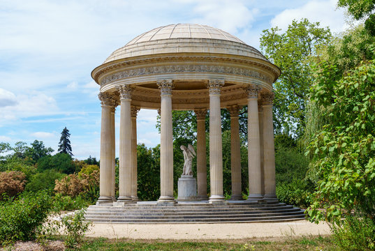 Versailles, France - August 02, 2020: Versailles Palace, Petit Trianon garden - Temple of love with the statue of Cupidon