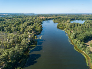 Fototapeta na wymiar Panoramic view of the Dnieper river in Kiev. Sunny clear day. Aerial drone view.