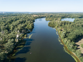 Panoramic view of the Dnieper river in Kiev. Sunny clear day. Aerial drone view.