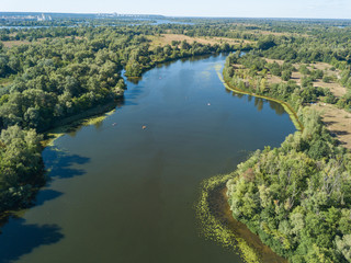 Fototapeta na wymiar Green bank of the Dnieper river on a summer sunny day. Aerial drone view.