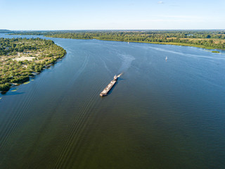 Aerial drone view. The barge sails along the Dnieper River.