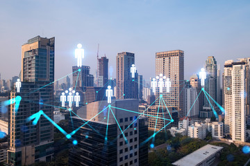 Hologram of social media icons over sunset panoramic cityscape of Bangkok, Asia. The concept of people connections. Multi exposure.