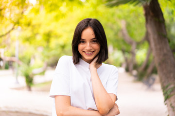 Young happy caucasian woman at outdoors