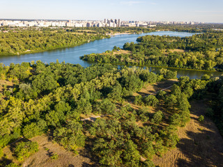 Panoramic view of the Dnieper river in Kiev. Sunny clear day. Aerial drone view.