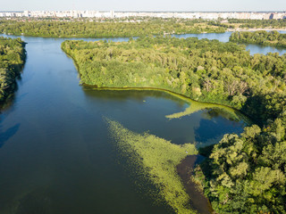 Fototapeta na wymiar Green bank of the Dnieper river on a summer sunny day. Aerial drone view.
