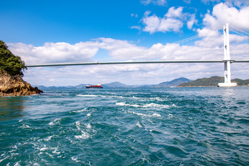 瀬戸内海しまなみ海道・来島海峡大橋と航行する船　The view of Kurushima-Kaikyo-Ohashi Bridge and the ship at Kurushima Strait in Seto-naikai, Inland sea of Japan, Imabari city, Ehime pref. Japan