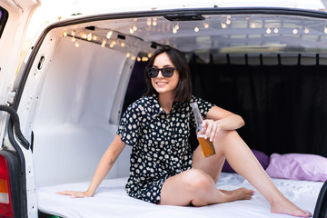 Young caucasian woman in a camper van at outdoors