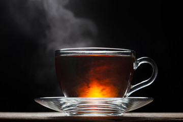 Cup of hot English tea on a black background. close up