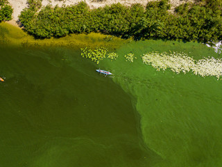 Kayak boat in the green water of the Dnieper river. Aerial drone view.
