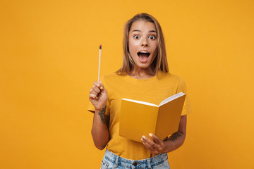 Image of young surprised woman holding exercise book