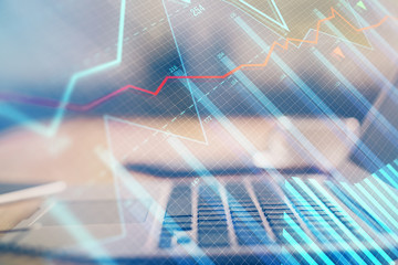 Double exposure of forex chart and work space with computer. Concept of international online trading.