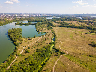 Fototapeta na wymiar Aerial drone view. Green meadows by the river.