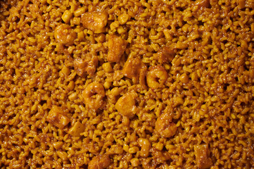 Traditional paella typical of Spain in traditional frying pan on white background