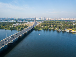 Fototapeta premium Dnieper River and North Bridge in Kiev. Sunny summer day, aerial drone view.
