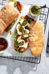 Fresh whole grain bun with tomato, pesto and mozarella. Copy space.