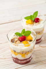 homemade mango and raspberry with yogurt and granola