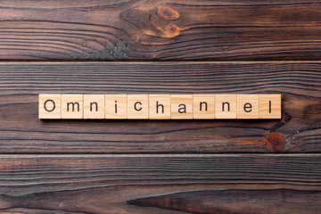 OMNICHANNEL word written on wood block. OMNICHANNEL text on cement table for your desing, concept