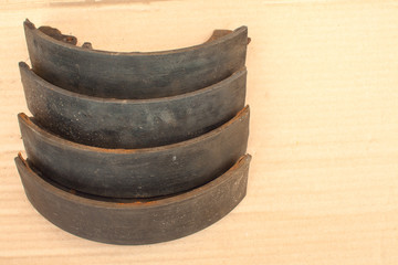 Old brake pads are stacked on top of each other. Copy space. Timely replacement of brake pads.