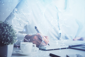 Man's hands working with notes background. Genetic engineering and gene manipulation concept.