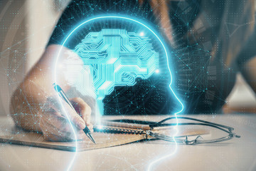 Multi exposure of woman's writing hand on background with brain hologram. Concept of brainstorming.