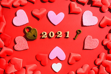 Love padlock on a red background with hearts for Valentine's Day in 2021.