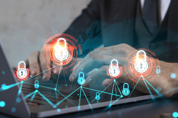 Businessman search for security options, typing laptop background and lock icons hologram.