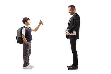 Schoolboy showing a smartphone to a man  holding books face masks