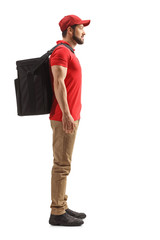 Full length profile shot of a food delivery guy standing with a bag on his back
