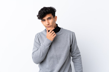 Young Argentinian man over isolated white background thinking